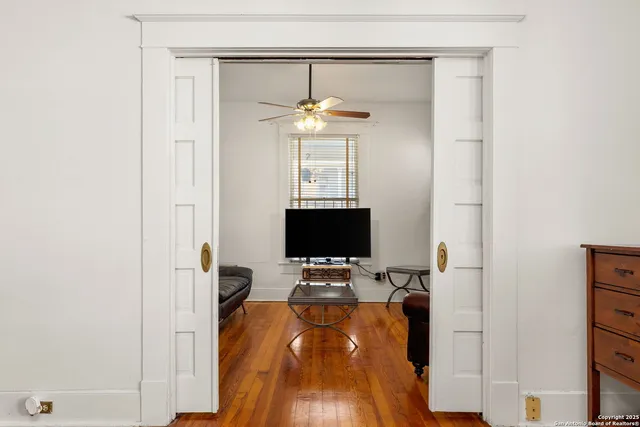 a living room with furniture a flat screen tv and a fireplace