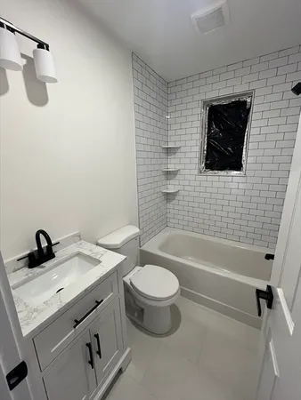 a bathroom with a sink a toilet and a bathtub