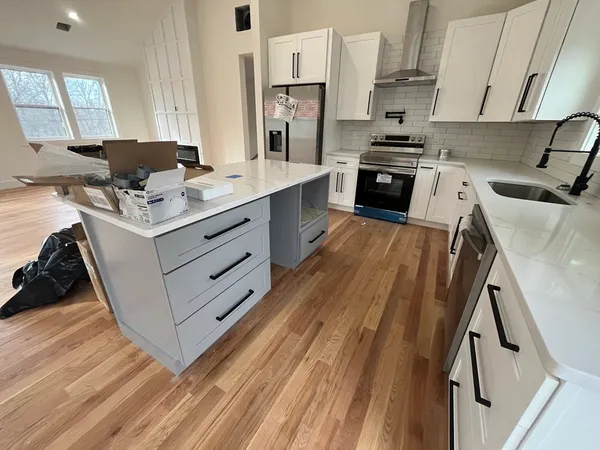 a kitchen with stainless steel appliances granite countertop a stove a sink dishwasher and a refrigerator