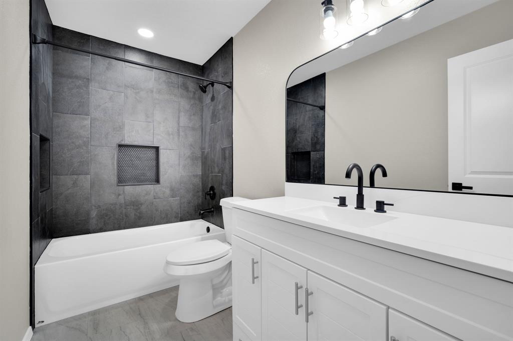 221 North Edgefield Road Waxahachie, TX 75165 - Photo 19 of 27 a bathroom with a sink a toilet and a mirror