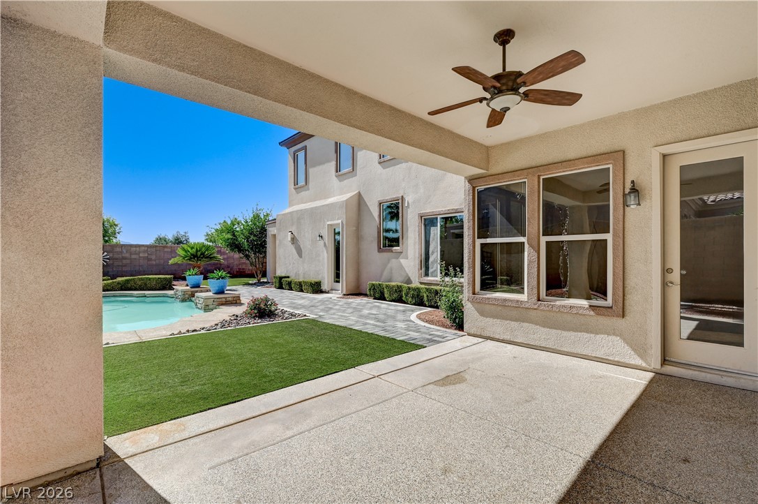 2793 Rosenhearty Drive Henderson, NV 89044 - Photo 57 of 77 Enjoy outdoor living with a private pool, lush green space, and a shaded patio area.