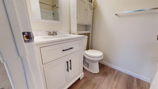 a bathroom with a sink a toilet and a mirror
