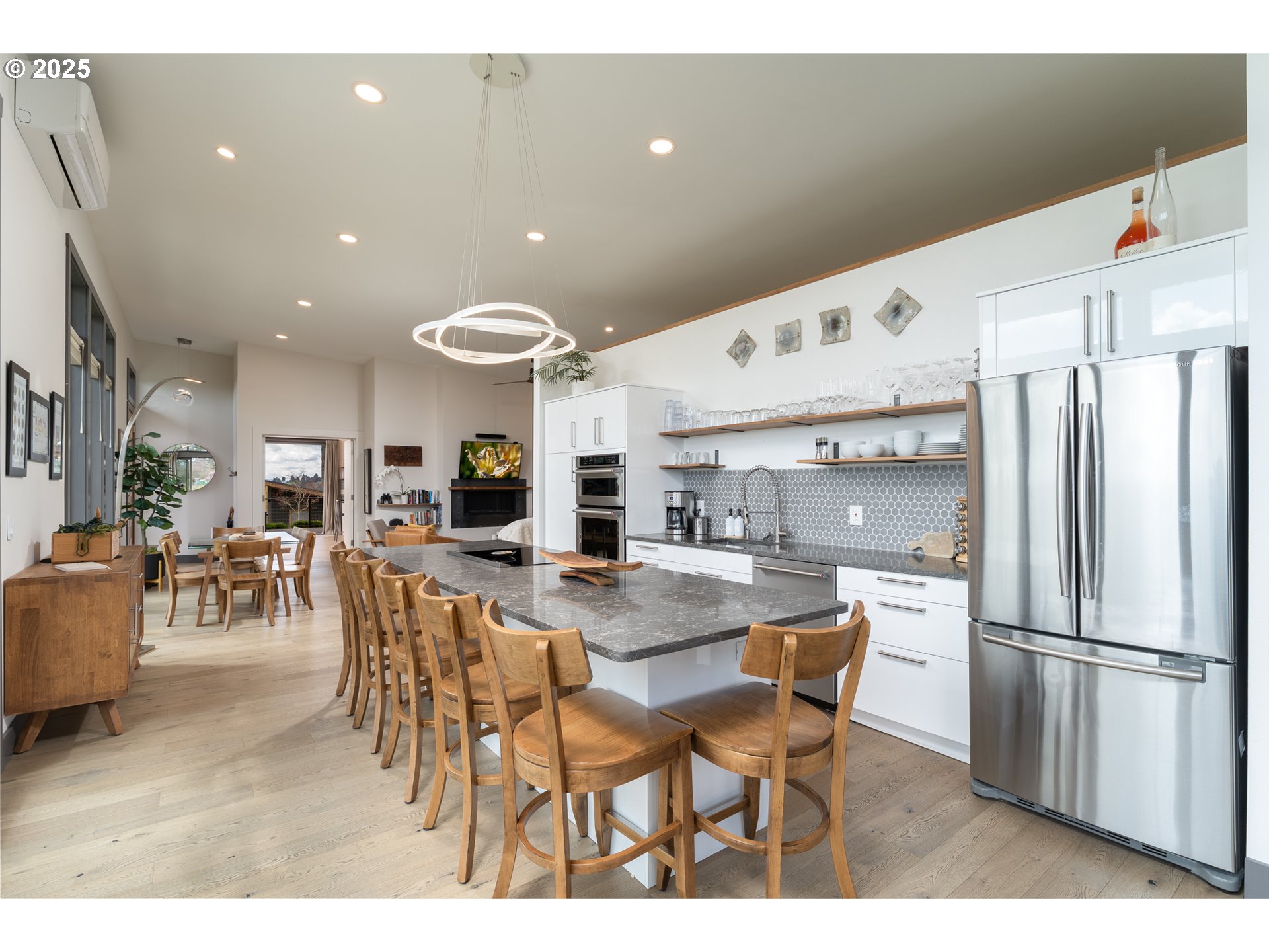 8331 Northeast Worden Hill Road Dundee, OR 97115 - Photo 12 of 48 a kitchen with stainless steel appliances kitchen island granite countertop a refrigerator a stove a microwave oven a dining table and chairs with wooden floor