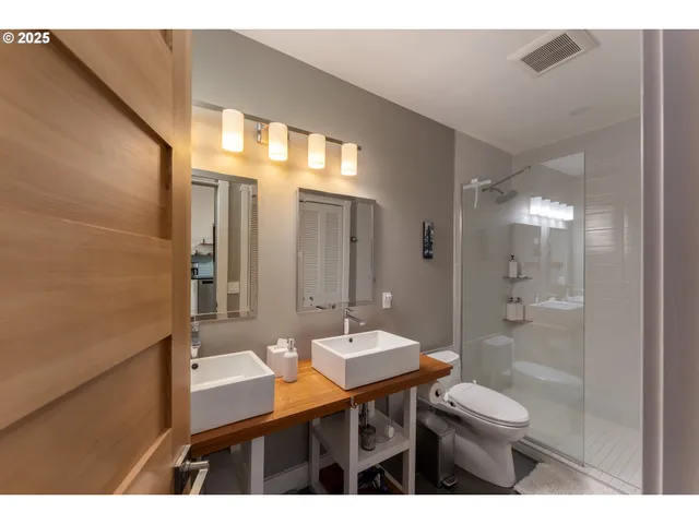 a bedroom with a bed and a night stand