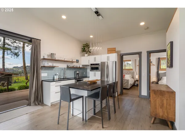 a kitchen with stainless steel appliances a sink a stove and refrigerator