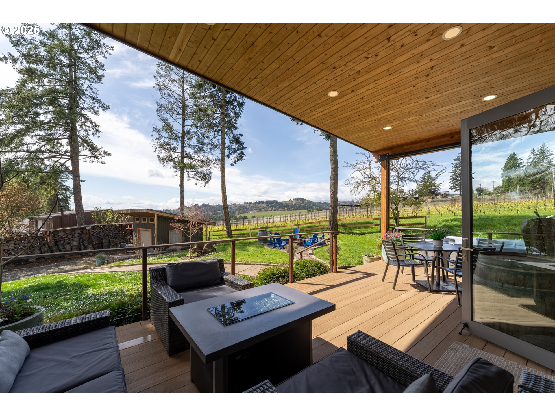 8331 Northeast Worden Hill Road Dundee, OR 97115 - Photo 22 of 48 a view of a patio with couches potted plants and wooden fence