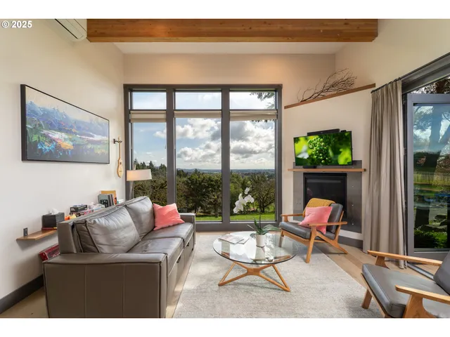 a kitchen with stainless steel appliances kitchen island granite countertop a refrigerator a stove a sink dishwasher and white cabinets with wooden floor