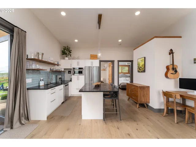 a living room with lots of furniture and kitchen view