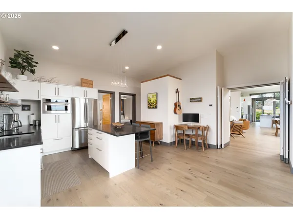 a living room with lots of furniture and kitchen view