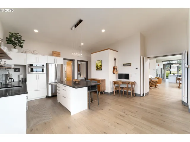 a living room with lots of furniture and kitchen view