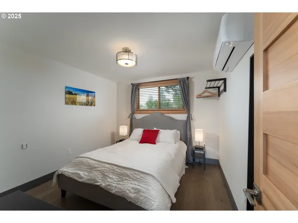 a bedroom with a bed and a lamp with window