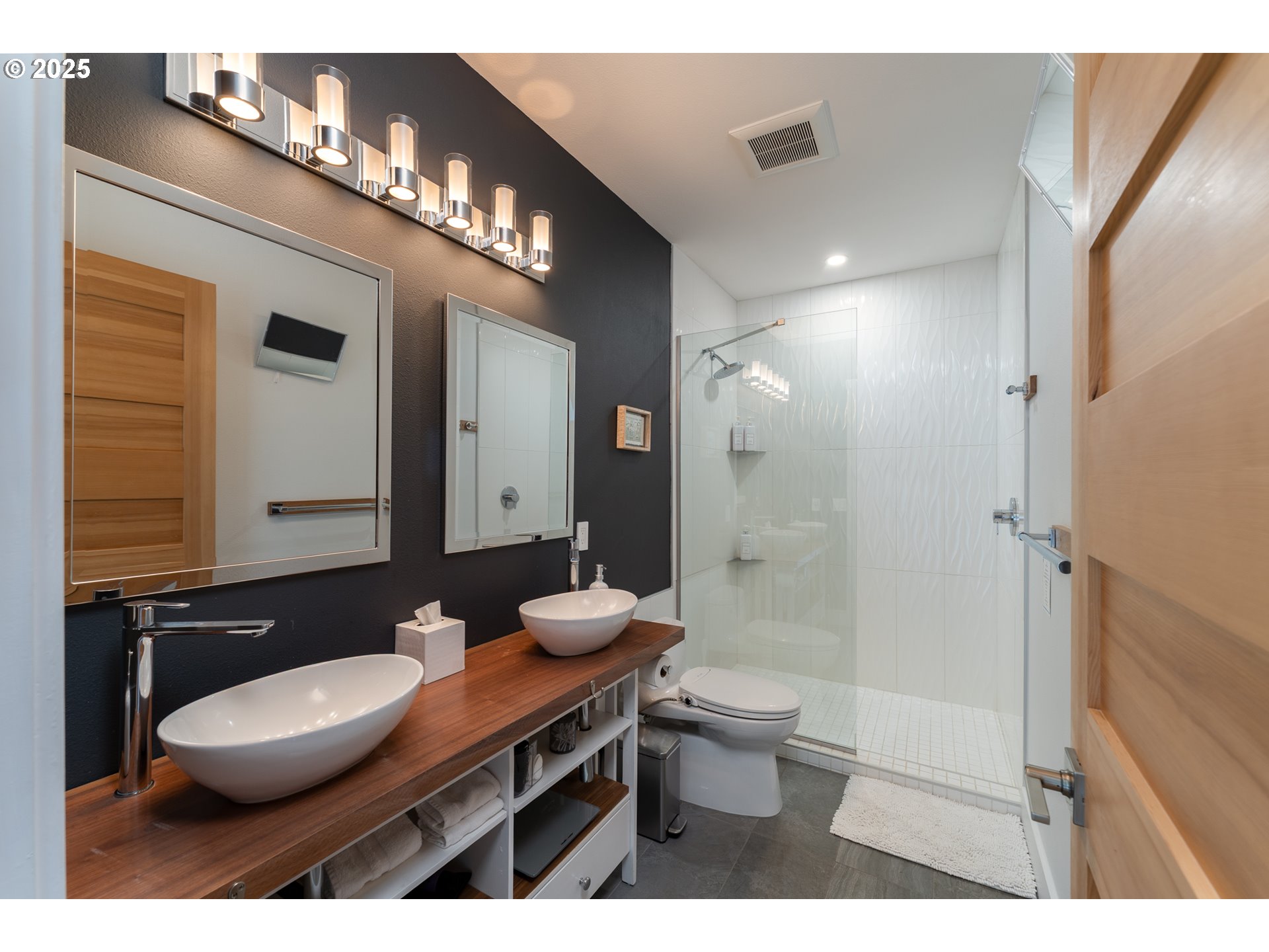 8331 Northeast Worden Hill Road Dundee, OR 97115 - Photo 32 of 48 a bathroom with a sink a toilet a large mirror and shower