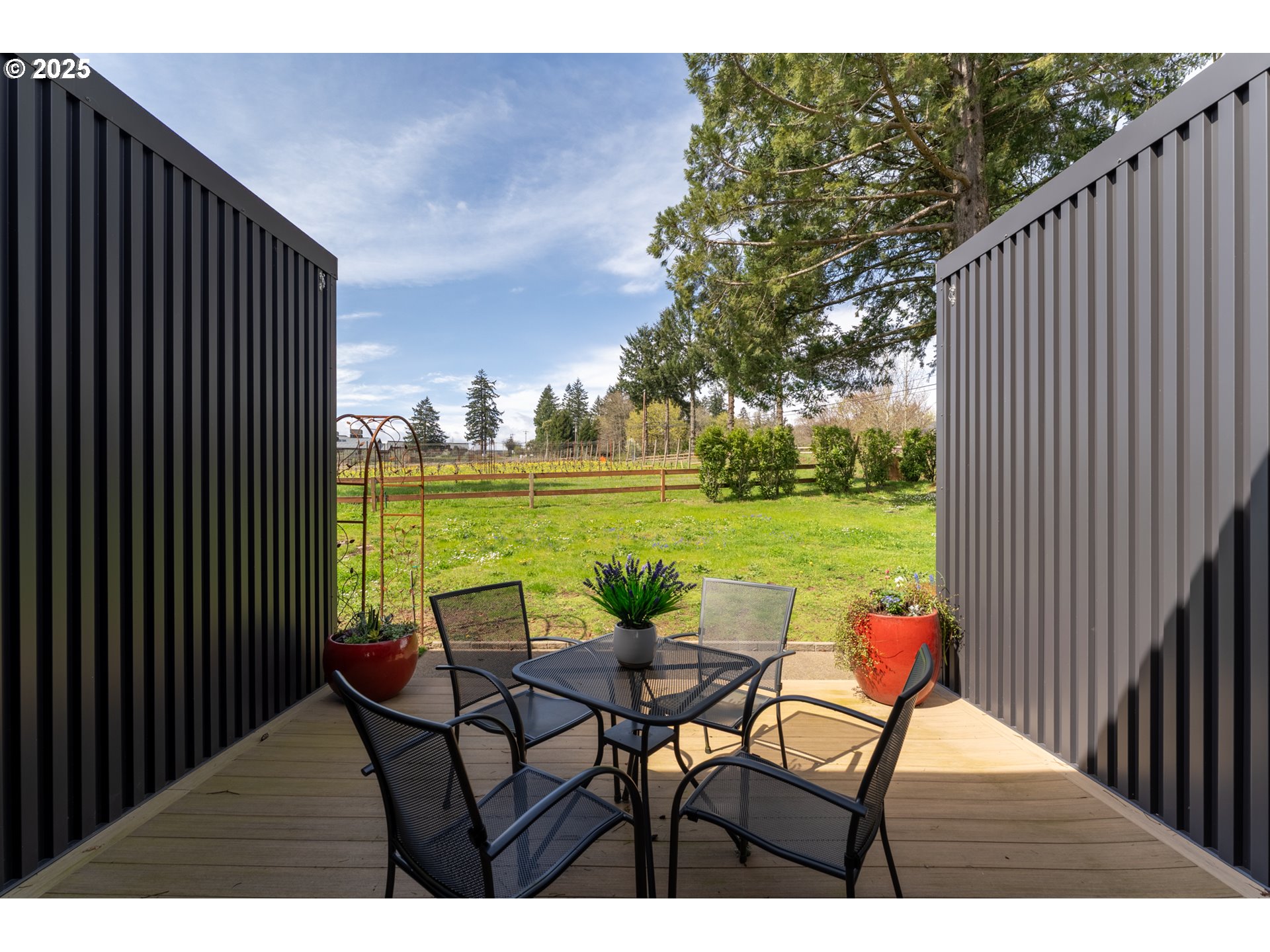 8331 Northeast Worden Hill Road Dundee, OR 97115 - Photo 6 of 48 a view of a lake from a balcony with table and chairs