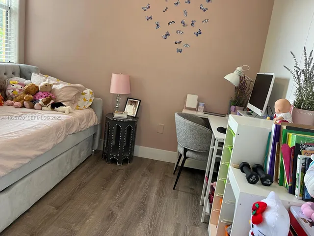 a bedroom with a bed and a desk