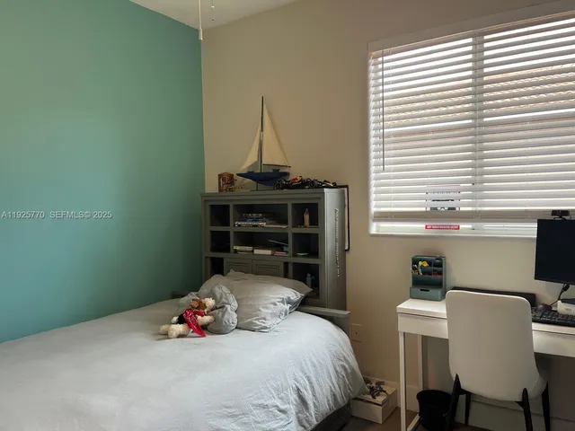 a bedroom with a bed and a table