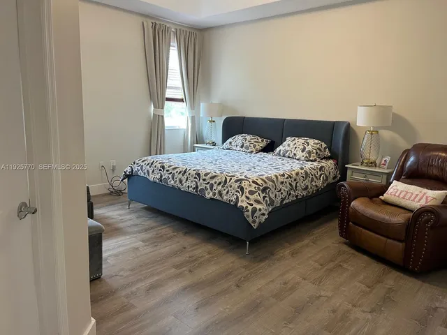 a bedroom with a bed couch and window