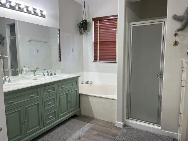 a bathroom with a sink mirror and a bathtub