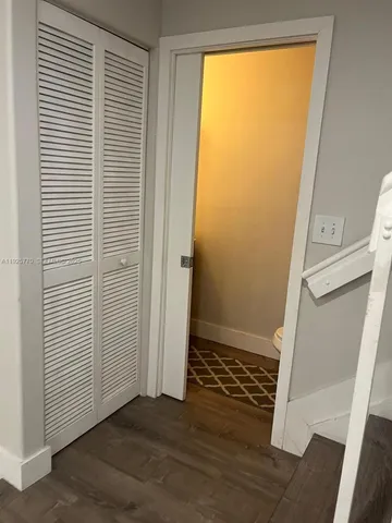 an empty room with wooden floor and a window