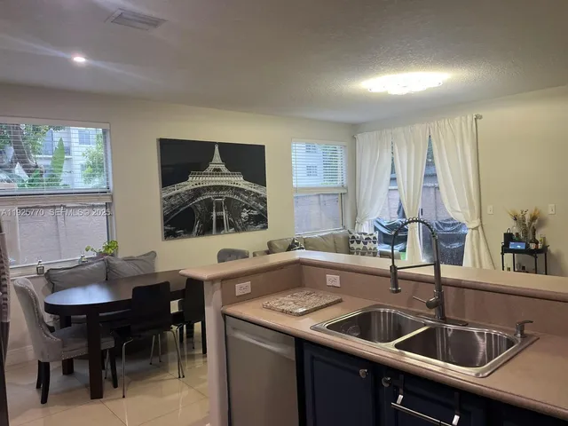 a kitchen with a sink and a stove top oven