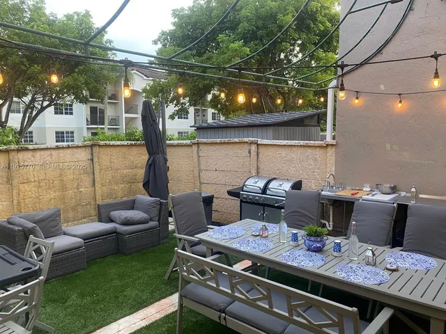 a roof deck with a table and chairs