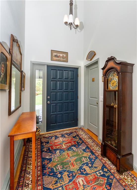 206 Quaker Hill Road Pawling, NY 12564 - Photo 12 of 36 Entryway with an inviting chandelier, a high ceiling, and wood-type flooring