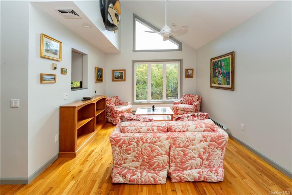206 Quaker Hill Road Pawling, NY 12564 - Photo 13 of 36 Living area featuring a baseboard radiator, light hardwood / wood-style floors, high vaulted ceiling, and ceiling fan