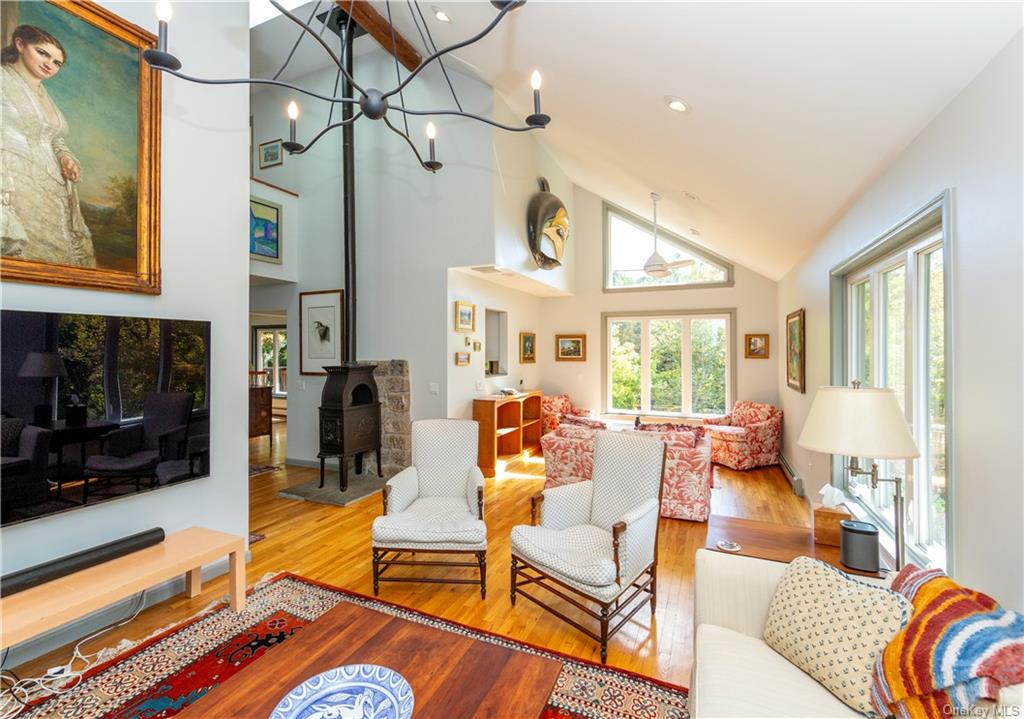 206 Quaker Hill Road Pawling, NY 12564 - Photo 16 of 36 Living room with a notable chandelier, light hardwood / wood-style floors, and high vaulted ceiling