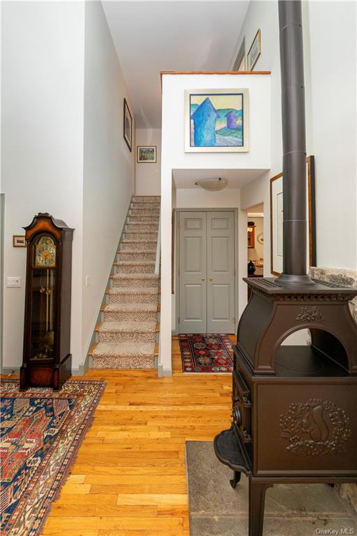 206 Quaker Hill Road Pawling, NY 12564 - Photo 18 of 36 Foyer with hardwood / wood-style flooring and a wood stove
