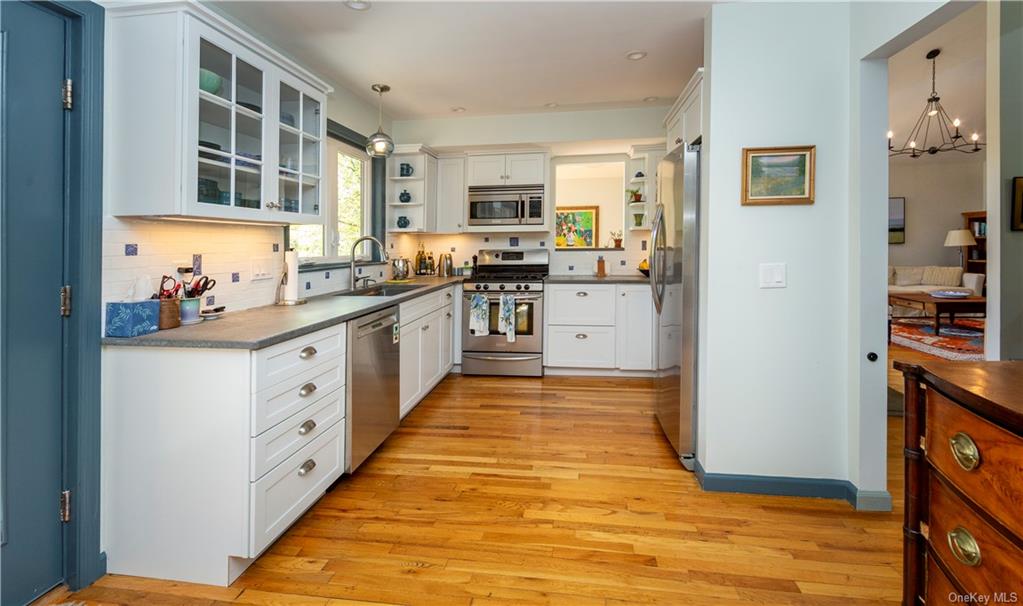206 Quaker Hill Road Pawling, NY 12564 - Photo 19 of 36 Kitchen featuring light hardwood / wood-style floors, appliances with stainless steel finishes, hanging light fixtures, and sink