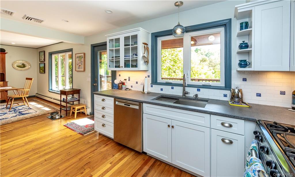 206 Quaker Hill Road Pawling, NY 12564 - Photo 20 of 36 Kitchen featuring light hardwood / wood-style floors, sink, white cabinetry, appliances with stainless steel finishes, and decorative light fixtures