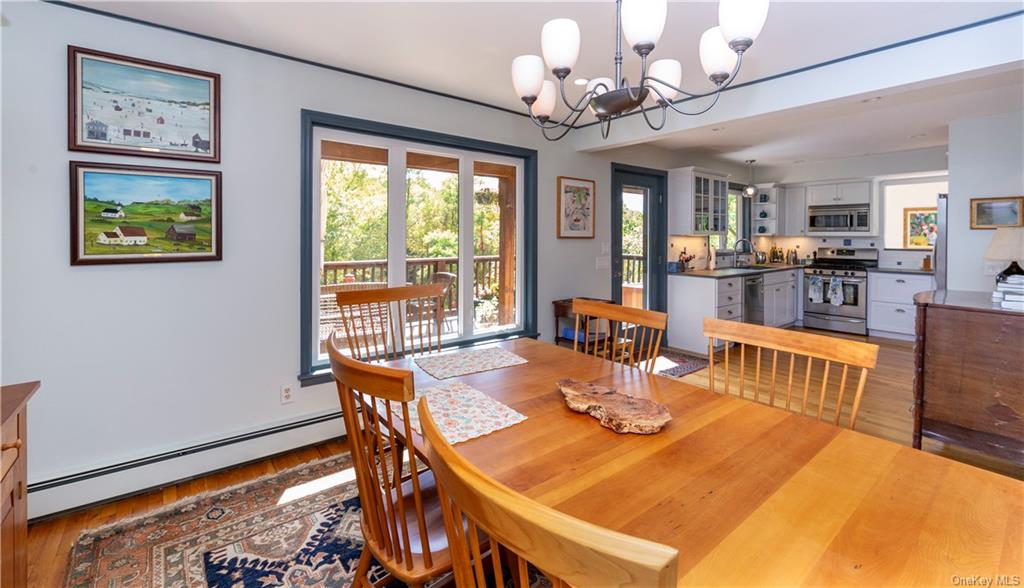206 Quaker Hill Road Pawling, NY 12564 - Photo 22 of 36 Dining room with a baseboard radiator, light wood-type flooring, a chandelier, and sink