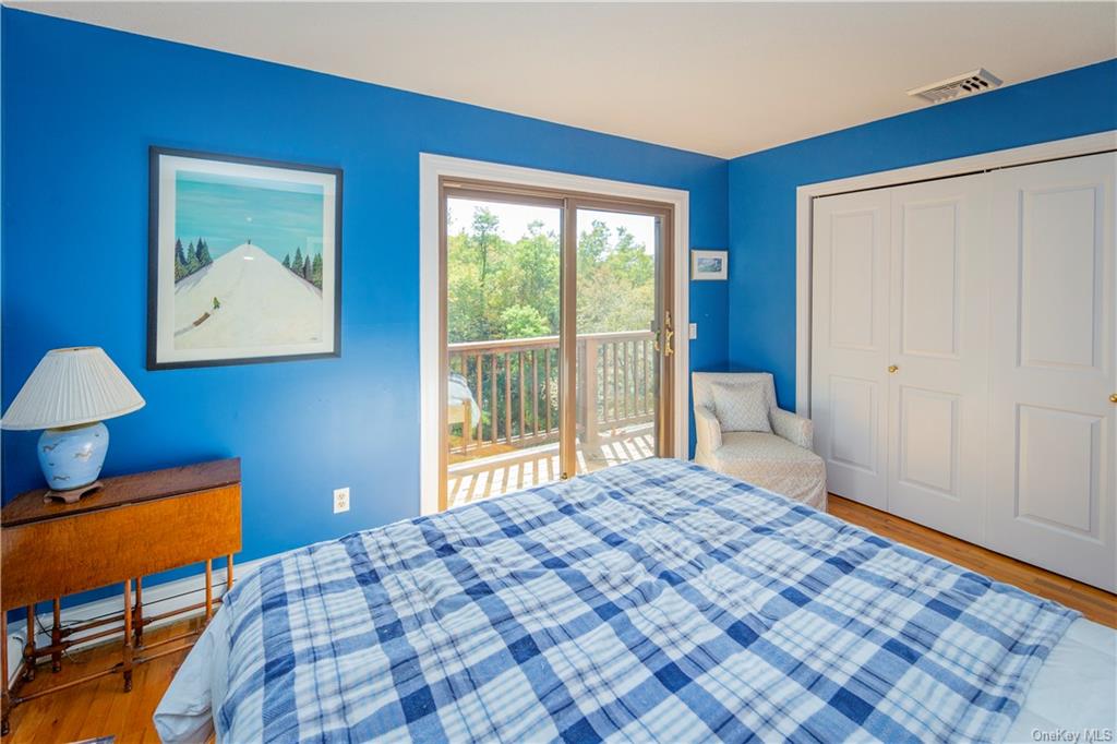 206 Quaker Hill Road Pawling, NY 12564 - Photo 27 of 36 Bedroom featuring access to outside, a closet, and hardwood / wood-style floors