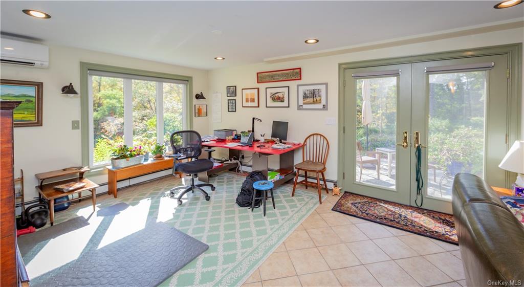 206 Quaker Hill Road Pawling, NY 12564 - Photo 32 of 36 Office area featuring a wall unit AC, light tile patterned flooring, and french doors