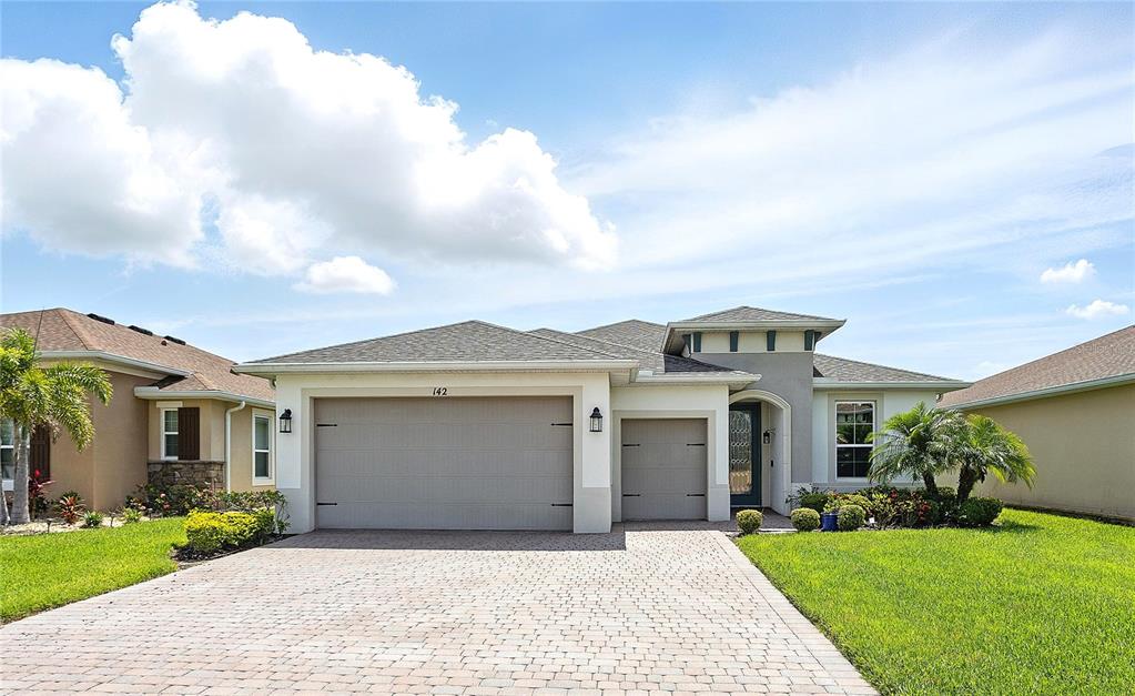 142 Olympus Way Kissimmee, FL 34759 - Photo 1 of 1 a front view of a house with a garden and yard