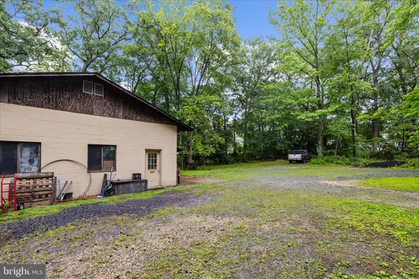 a backyard of a house with barbeque oven table and chairs