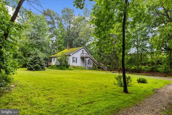 a yellow house in middle of the forest
