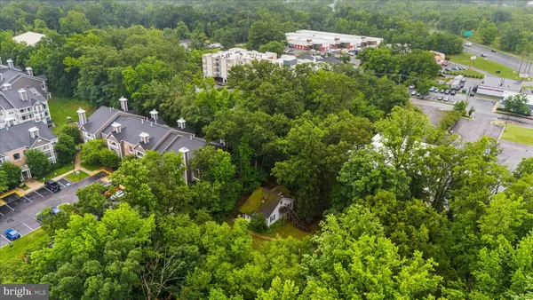 an aerial view of a house with a yard basket ball court and outdoor seating