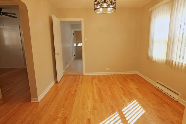 a view of a room with wooden floor and a window