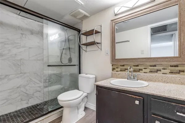 a bathroom with a sink toilet and shower