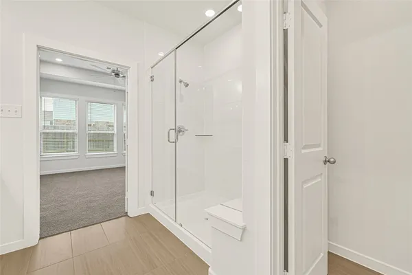 a bathroom with a shower and a glass door