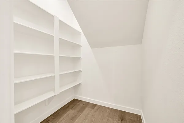 a view of walk in closet with empty racks