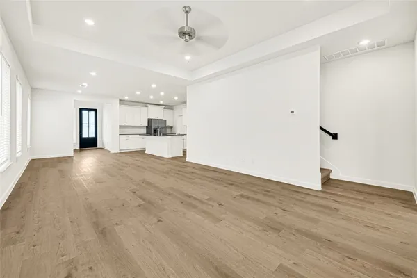 a view of a kitchen with a sink and wooden floor