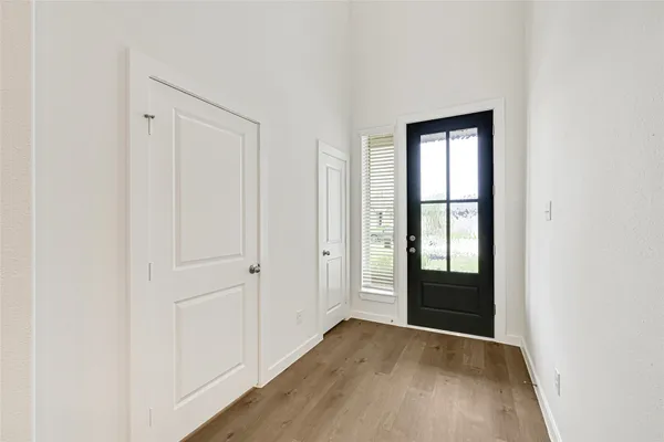 an empty room with windows and closet
