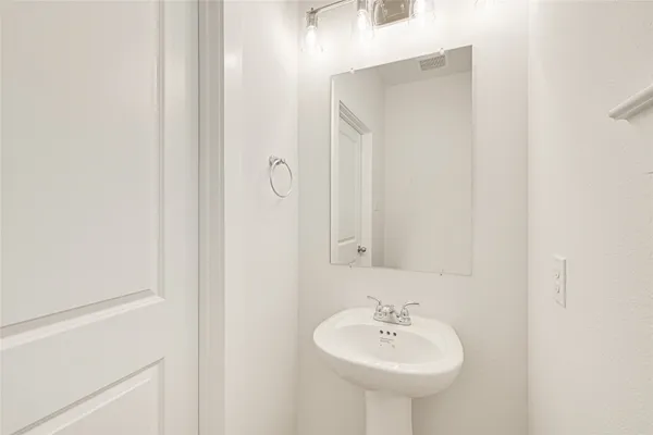 a bathroom with a sink a mirror and a shower