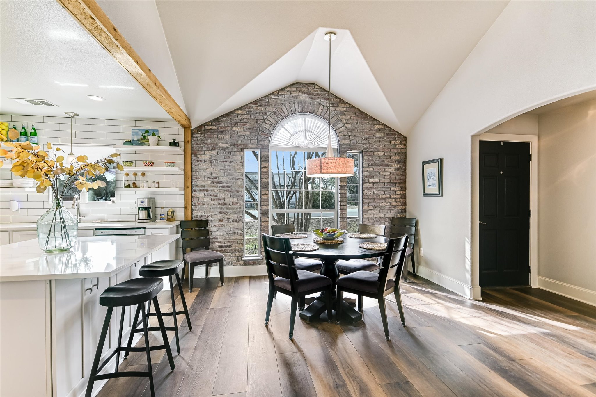 18516 Champions Circle Lago Vista, TX 78645 - Photo 11 of 30 a dining room with furniture a chandelier and wooden floor