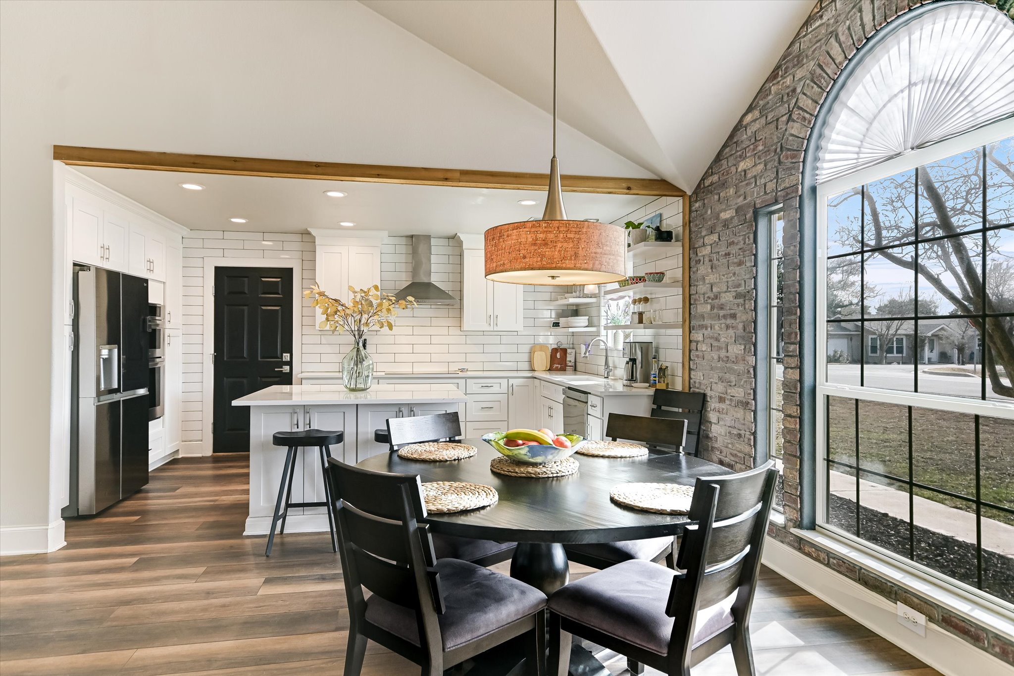 18516 Champions Circle Lago Vista, TX 78645 - Photo 13 of 30 a dining room with stainless steel appliances kitchen island a table and chairs
