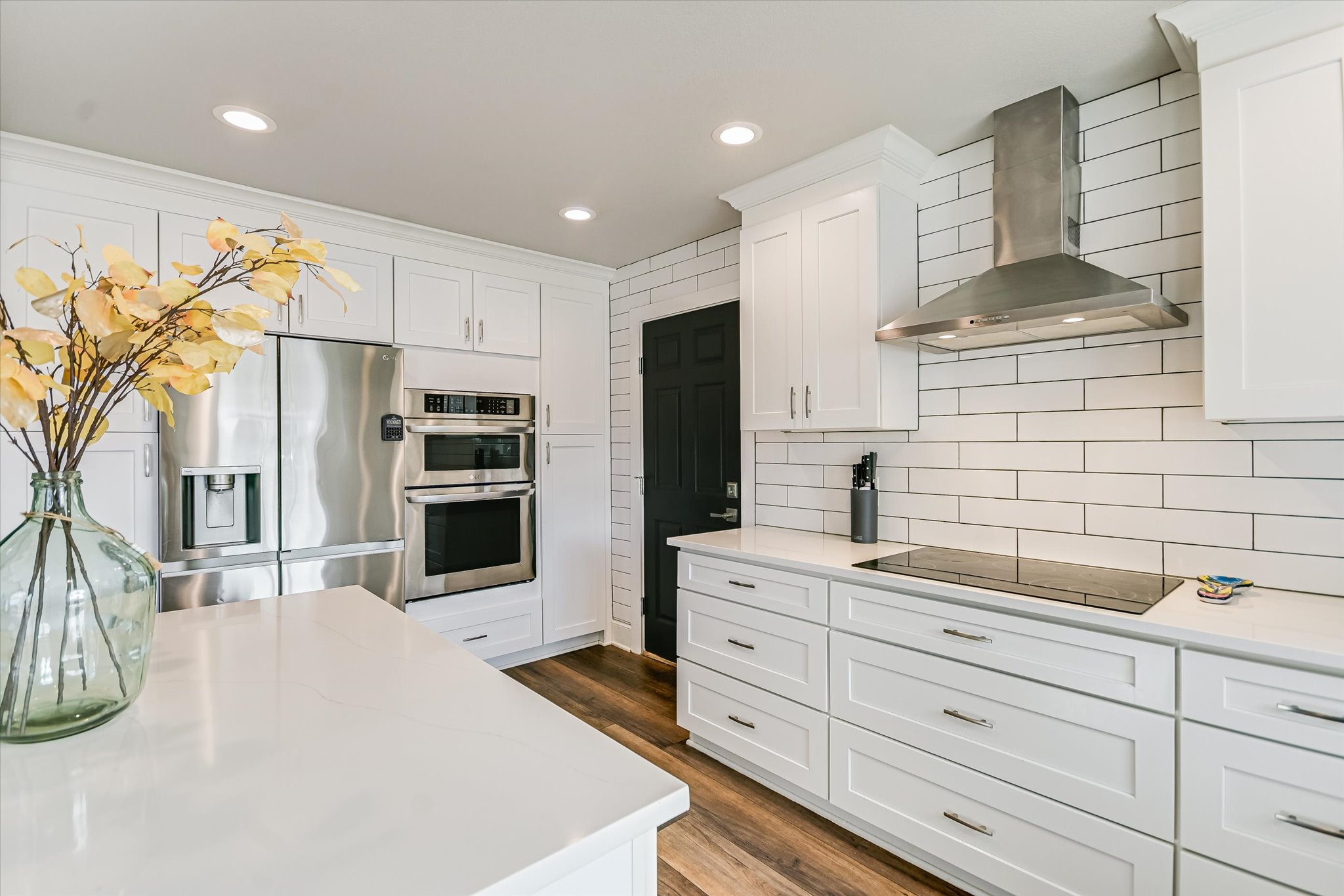 18516 Champions Circle Lago Vista, TX 78645 - Photo 15 of 30 a kitchen with stainless steel appliances kitchen island granite countertop a refrigerator and cabinets