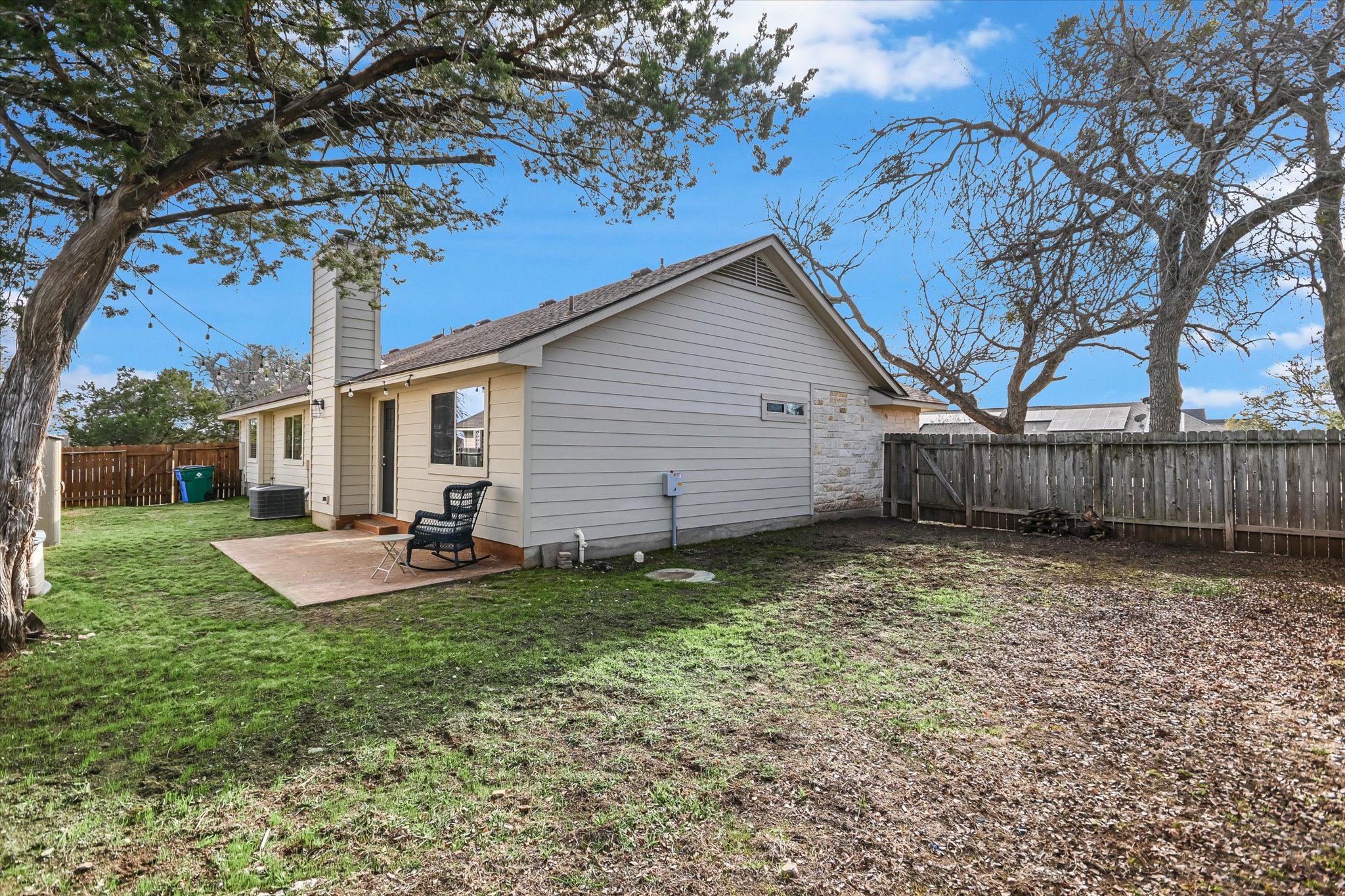 18516 Champions Circle Lago Vista, TX 78645 - Photo 17 of 30 a backyard of a house with seating space