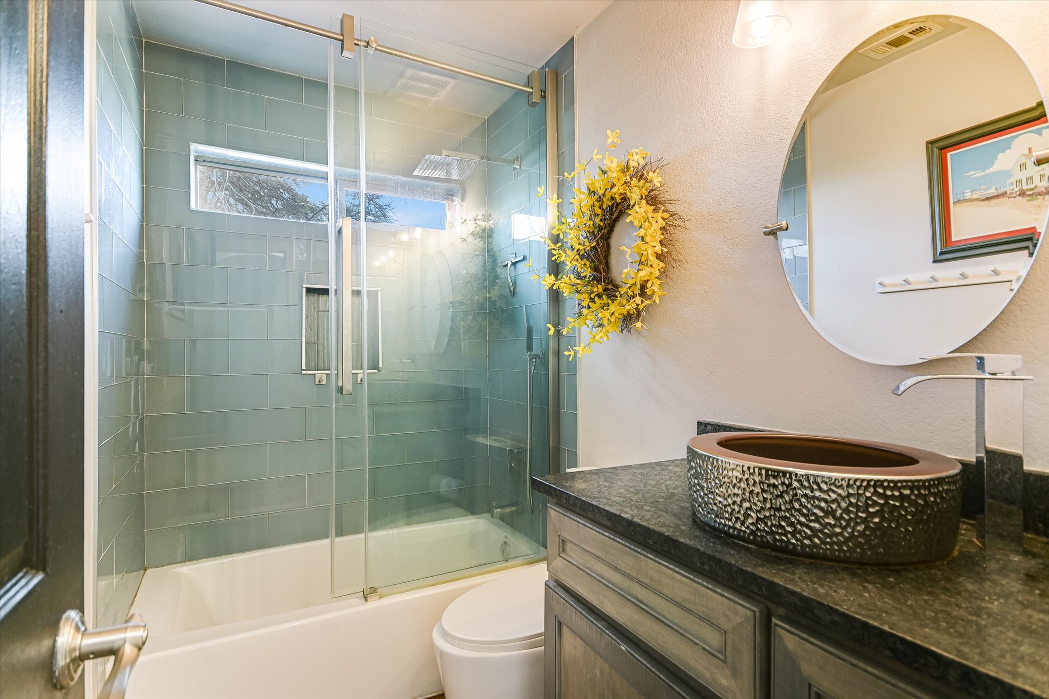 18516 Champions Circle Lago Vista, TX 78645 - Photo 8 of 30 a bathroom with a granite countertop sink a toilet and shower