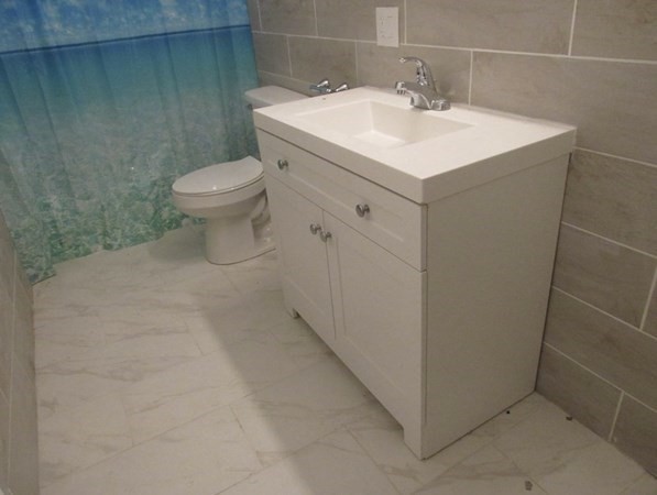 311-313 Providence Road Grafton, MA 01560 - Photo 11 of 21 a bathroom with a sink toilet and vanity